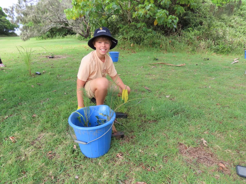 Boy planting a tree for Seeds of Hope event. 