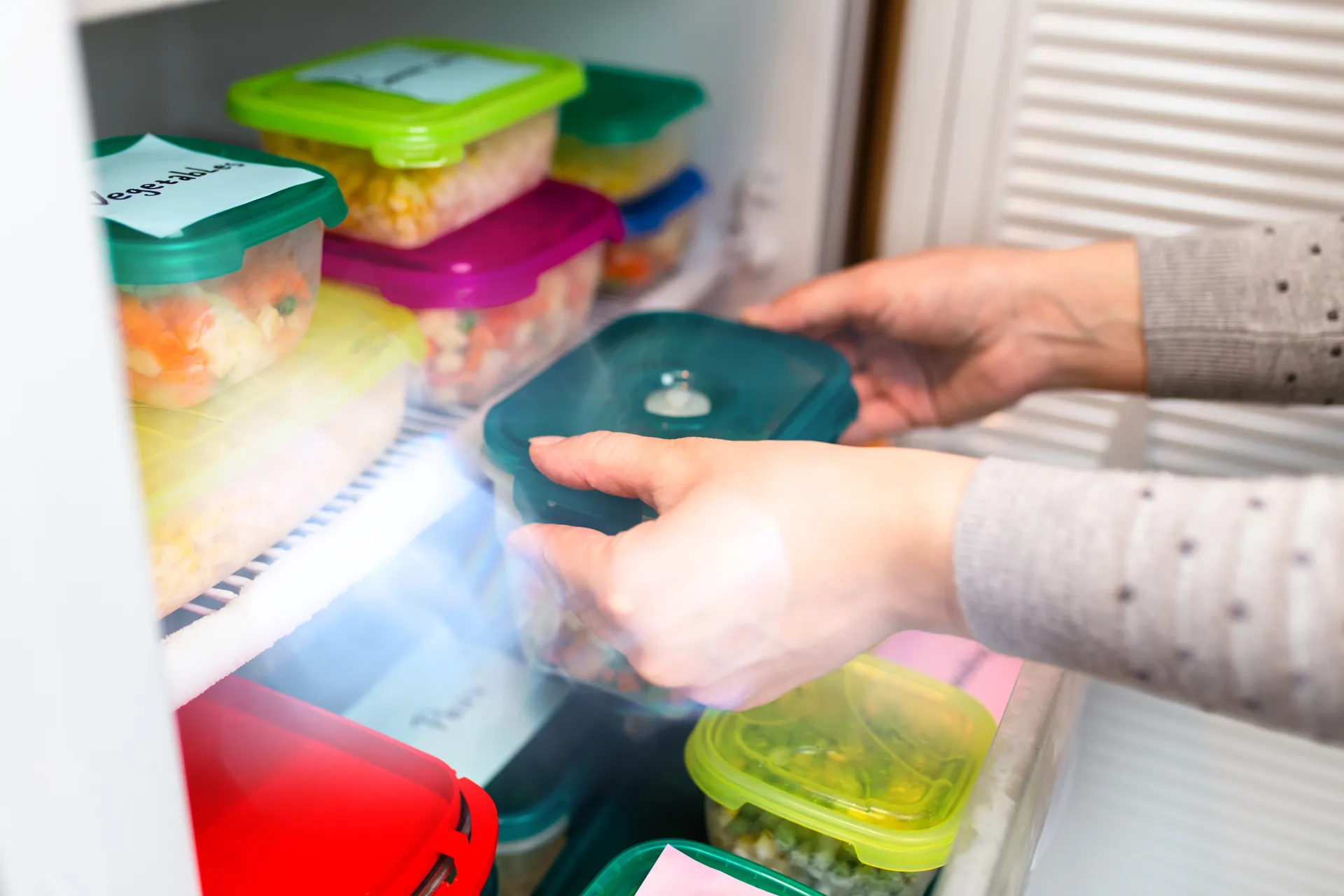 food labels on plastic containers in fridge