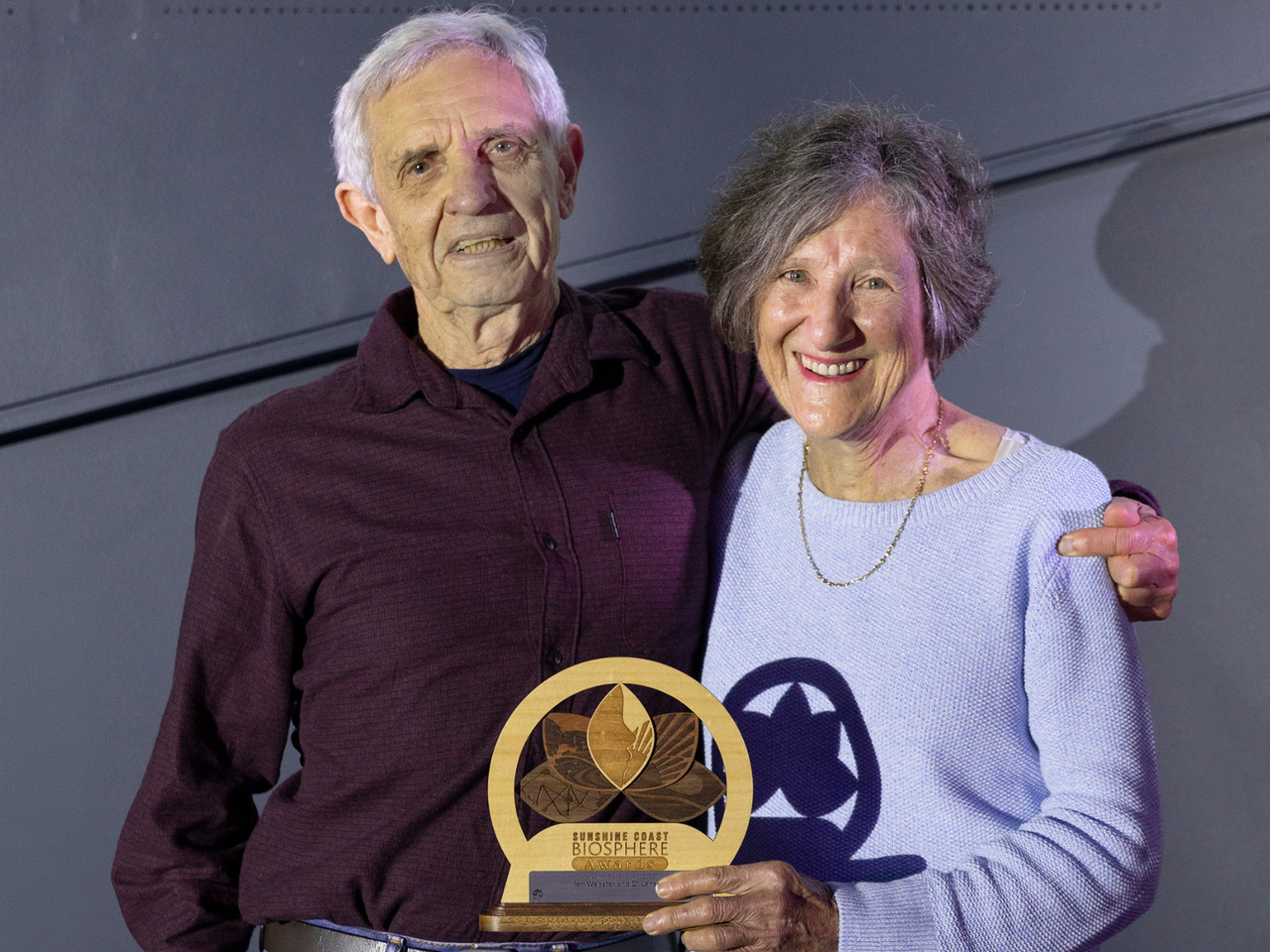 Elderly couple Ian and Di hold their Healthy Planet trophy.