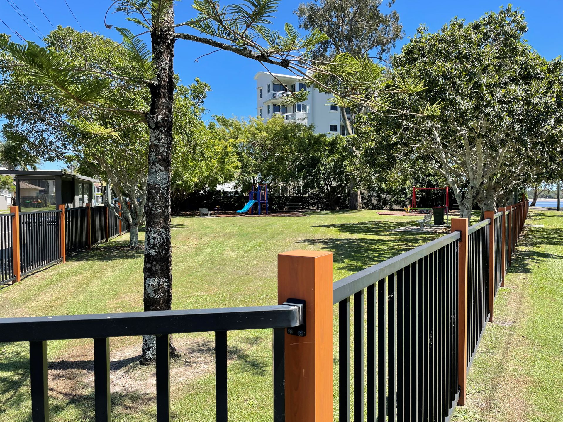 Fenced playground and green grass