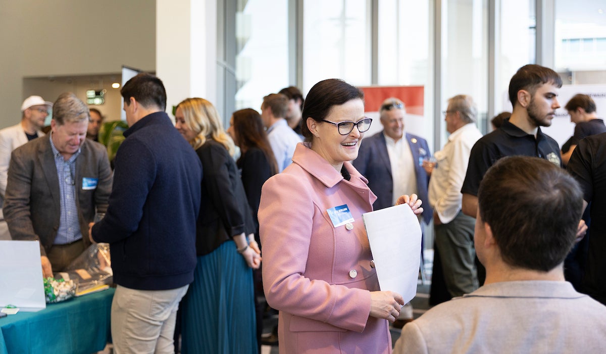 People at the Thriving Through Change event talk to exhibitors.