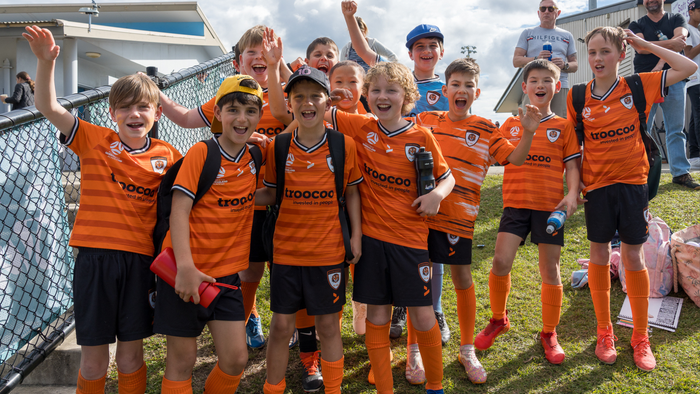 A group of young footballers in uniform.