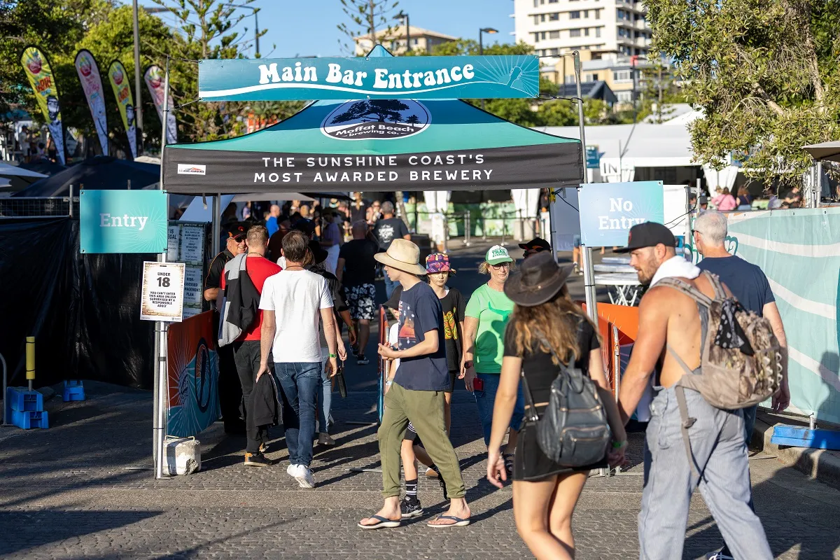 Festival patrons walking into the main bar area to enjoy a beverage and live music