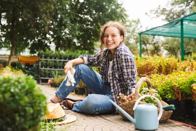 woman sitting in her garden ready to plant