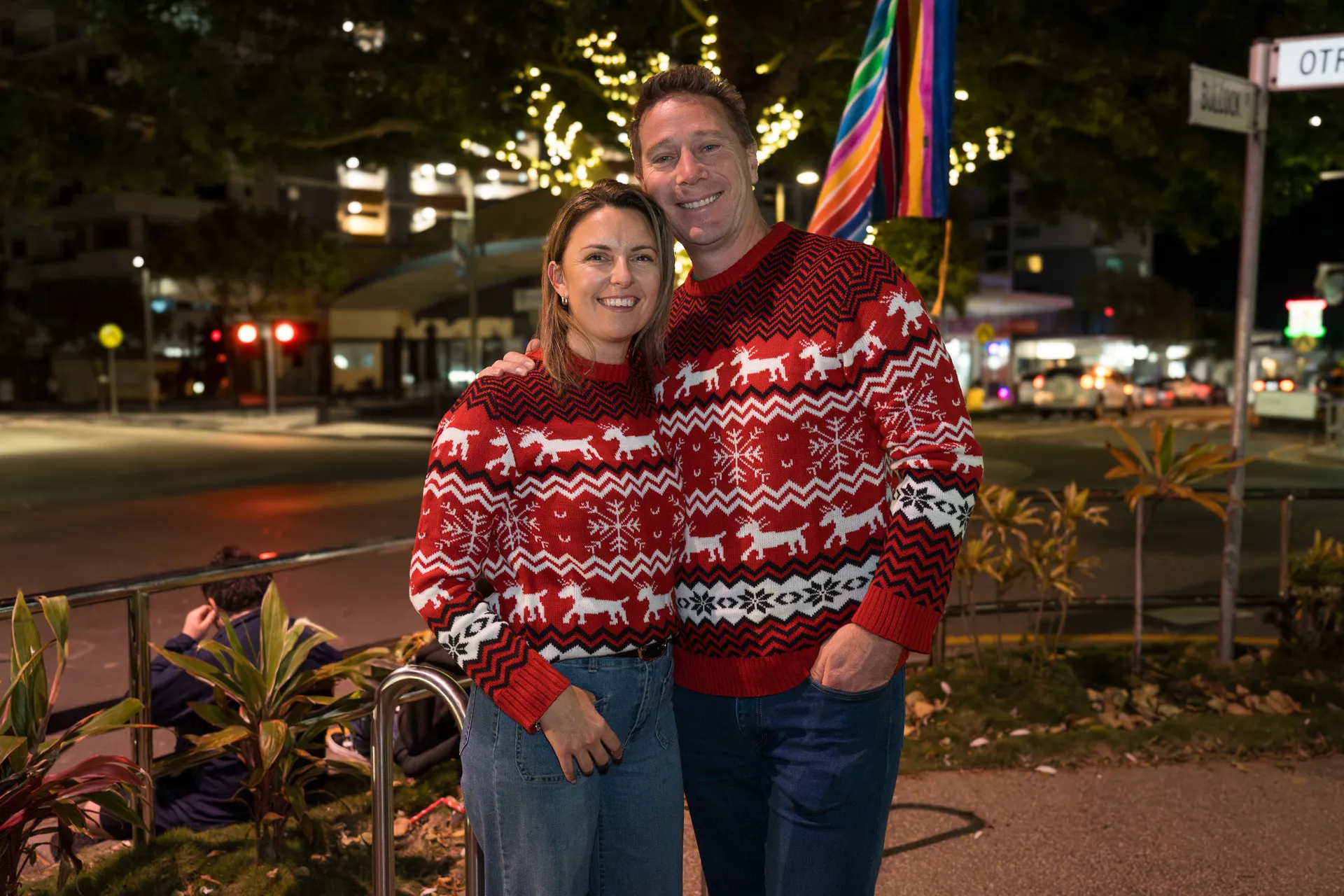 A couple in red Christmas looking jumpers