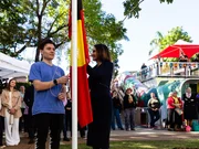 Community gathers for flag raising and cultural celebrations