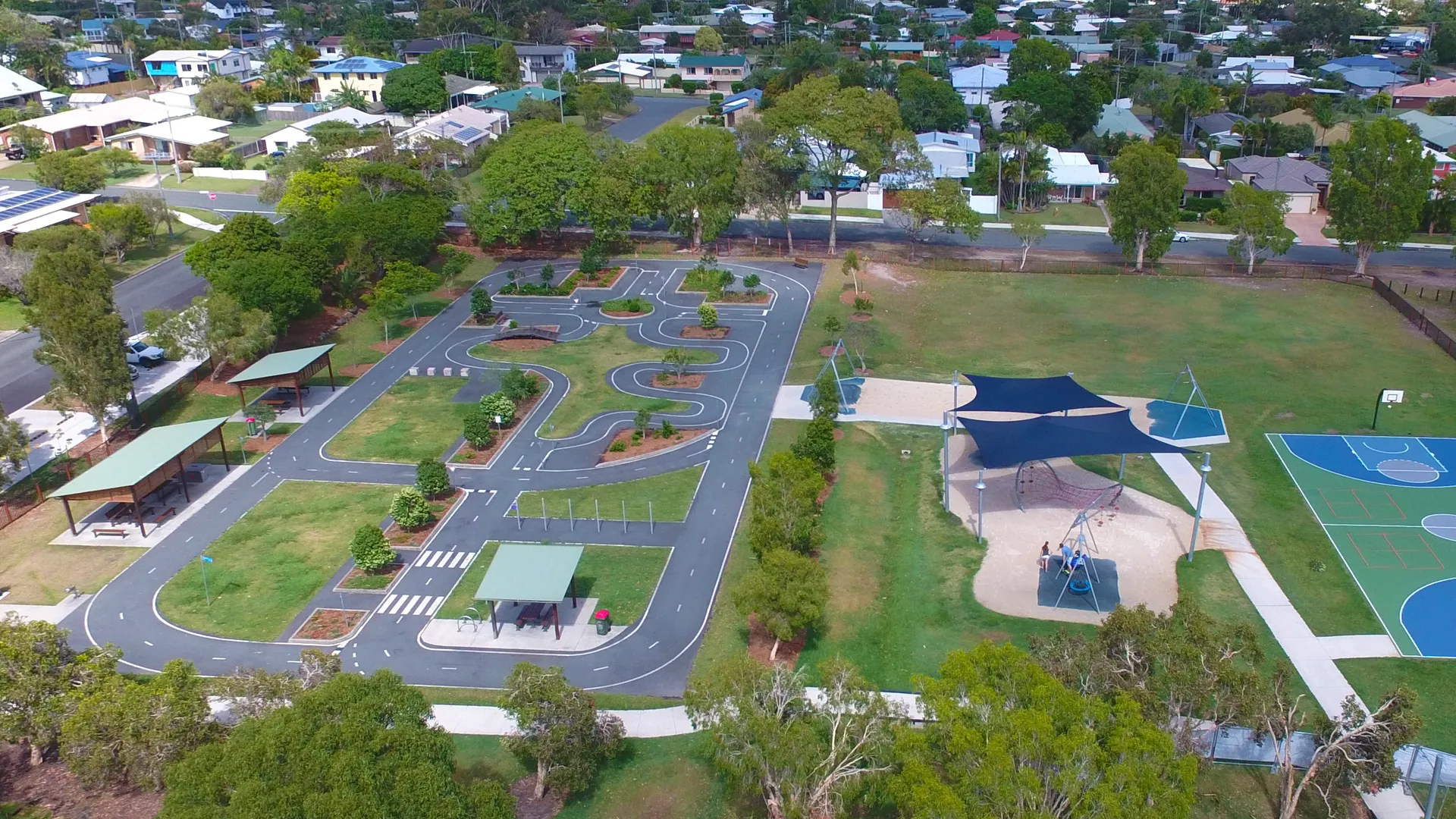 Areial view of playground and parkw ith shelters, bike track, swings and shade structures