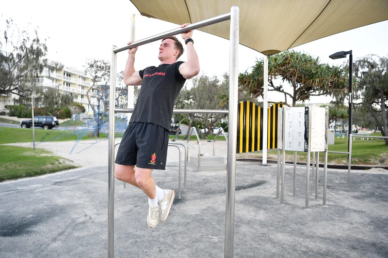 Man exercising at Kings Beach exercise park equipment