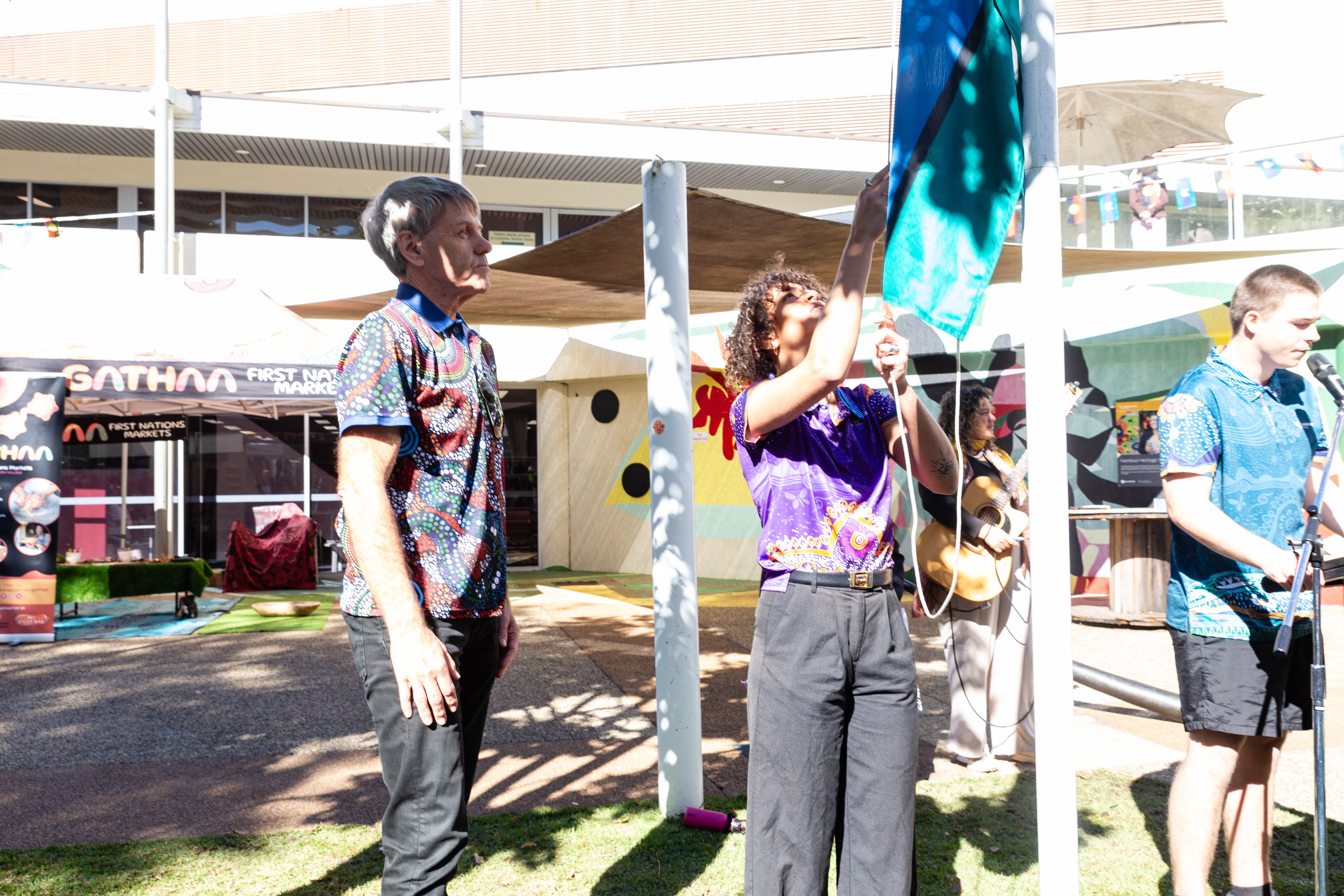 Raising the Torres Strait Islander flag.