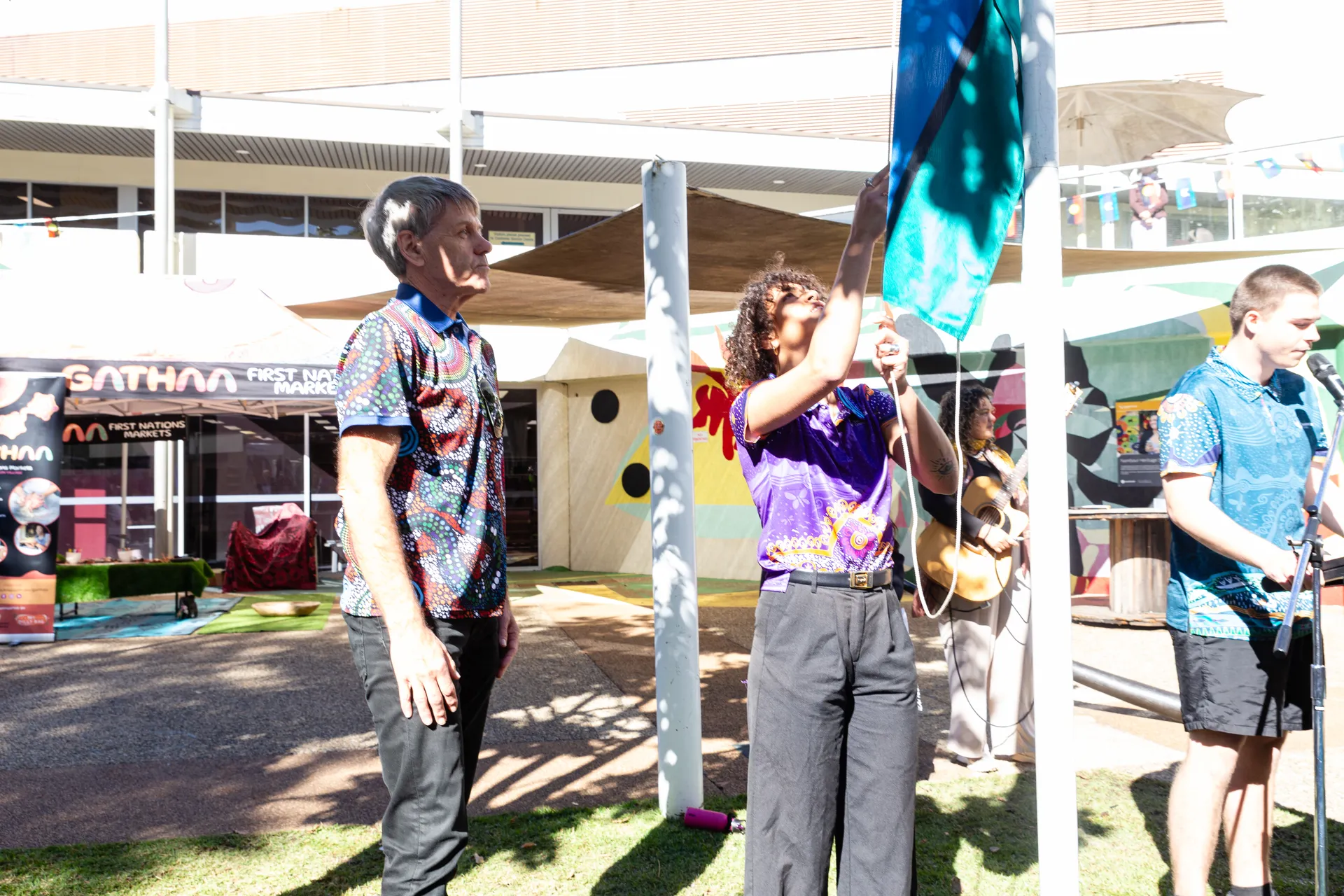 Raising the Torres Strait Islander flag.