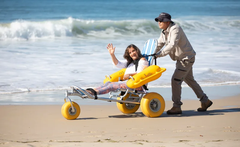 Person in beach wheelchair on the beach 