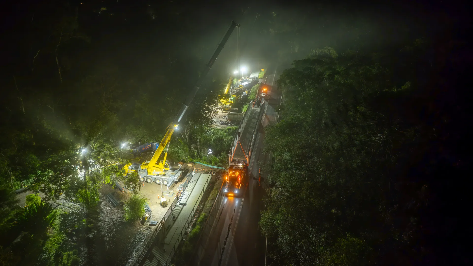 Aerial image of bridge being craned into place.