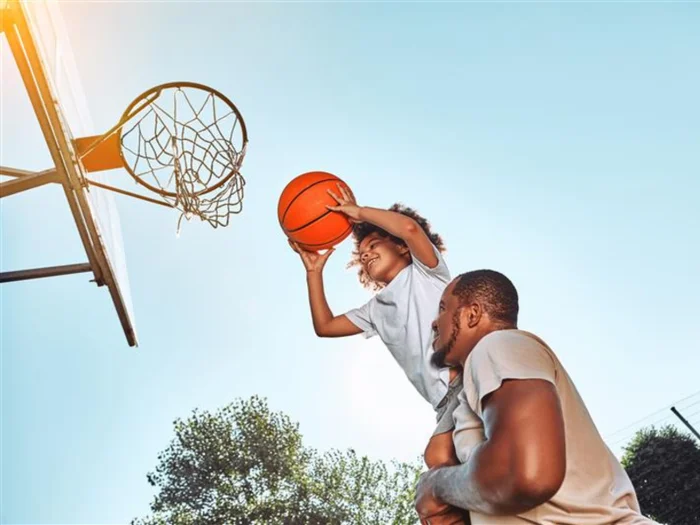 Father and son playing basketball.