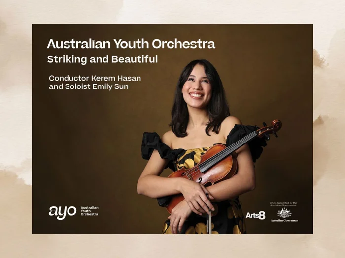 Australian Youth Orchestra. Image promoting an event featuring the condutor Kerem Hasan. Holding in her arms a beautiful violin. Background in soft choclate brown.