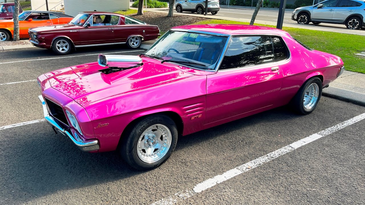 Downunder Beachfest of a pink vintage car. 