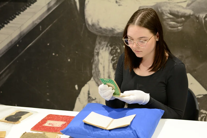 Cultural-Heritage-Support-Officer-Carita-Robinson-examines-collection-items.jpg