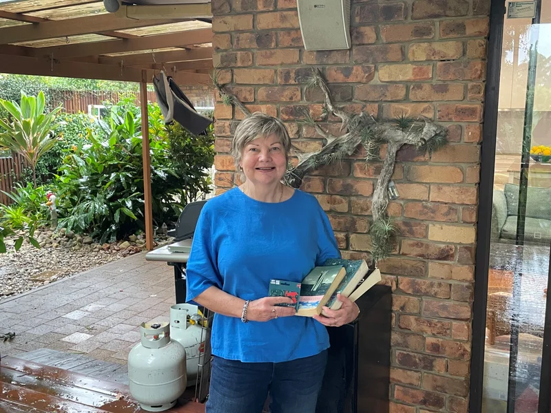 Image-1-Panels-Choice-Winner-Jane-Kruger-with-her-community-library-books.-scaled.jpg