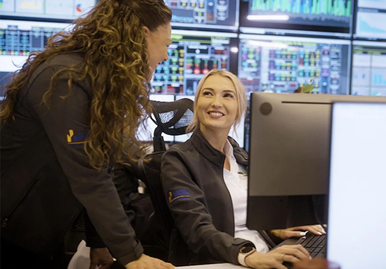 Two-ladies-talking-in-control-room-at-computer.jpg