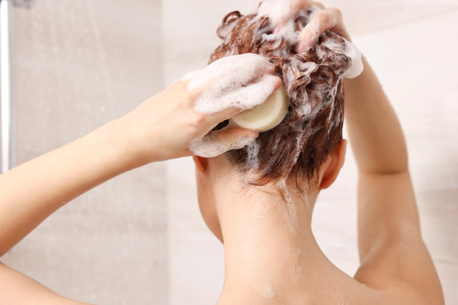 woman using a shampoo bar