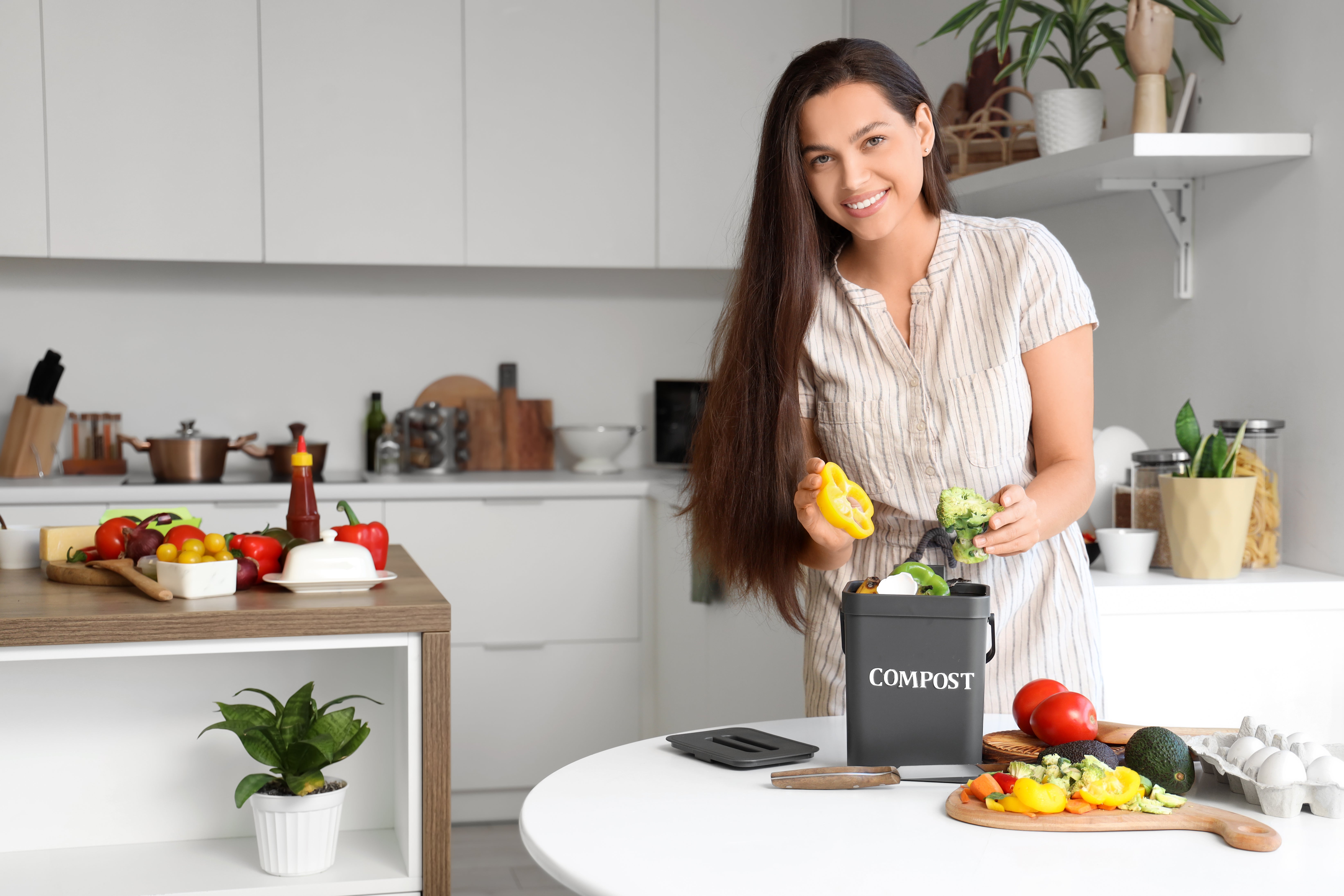 woman collecting kitchen scraps