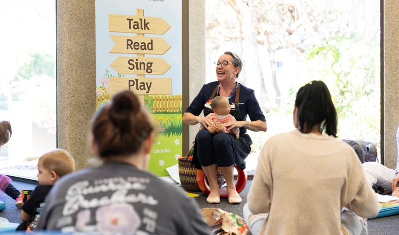 Sunshine Coast Libraries Rhymetime session at a local library, featuring the session leader and mums with their babies. 