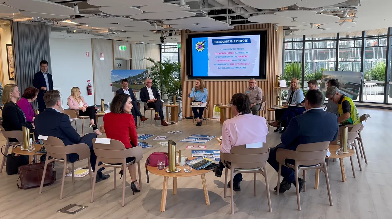 Representatives from all levels of government are in discussions, seated in a circle.