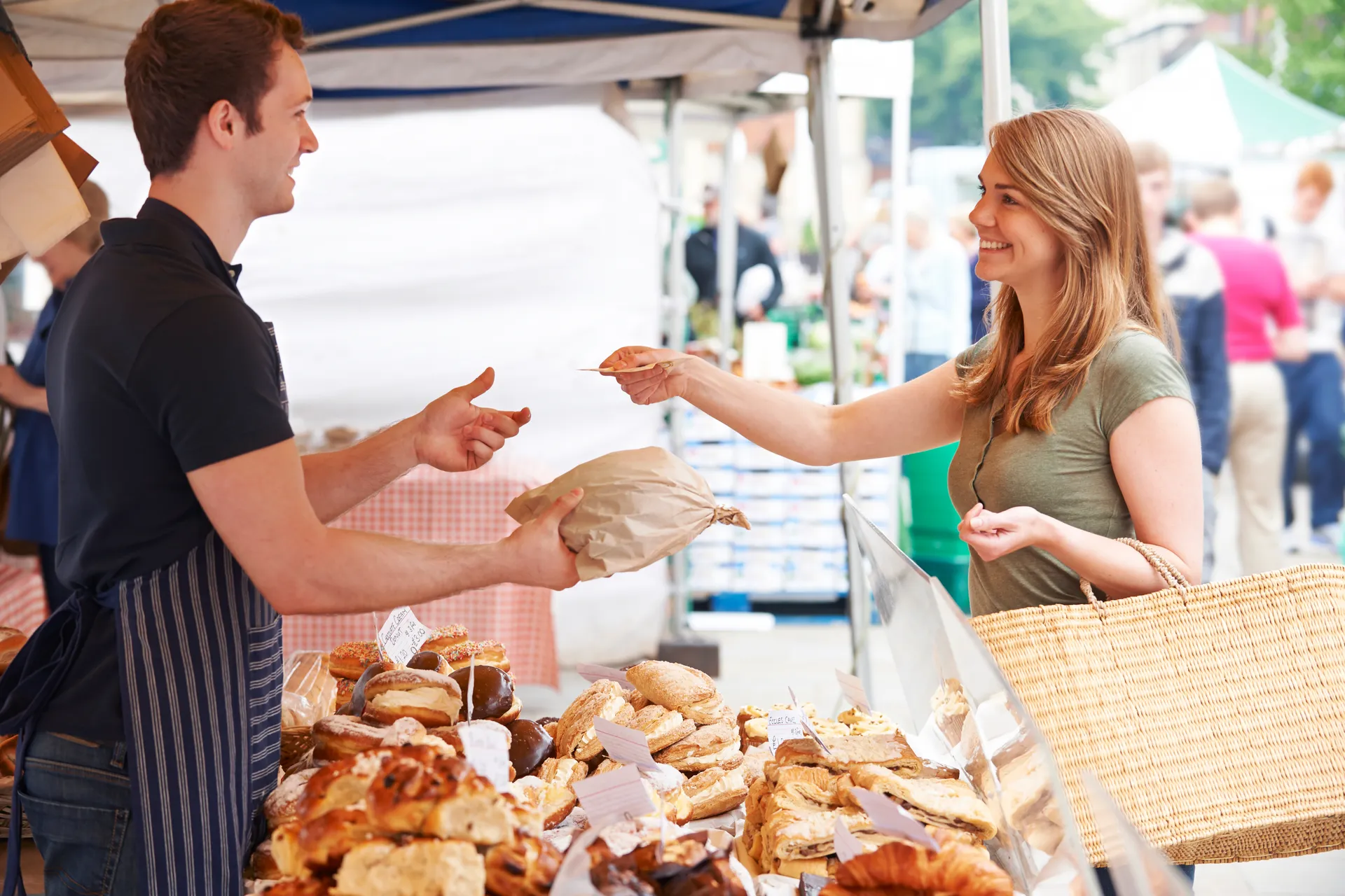 lady paying for bread at a market
