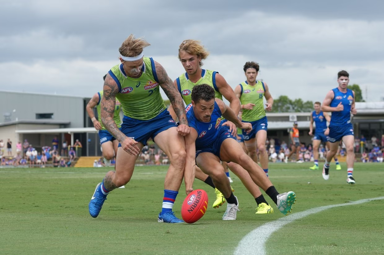 Three players chasing a football