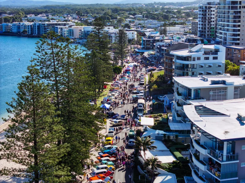 An aerial view of The Esplanade, Bulcock Beach Caloundra - with the street lined with classic cars, hot rodz and custom cars.
