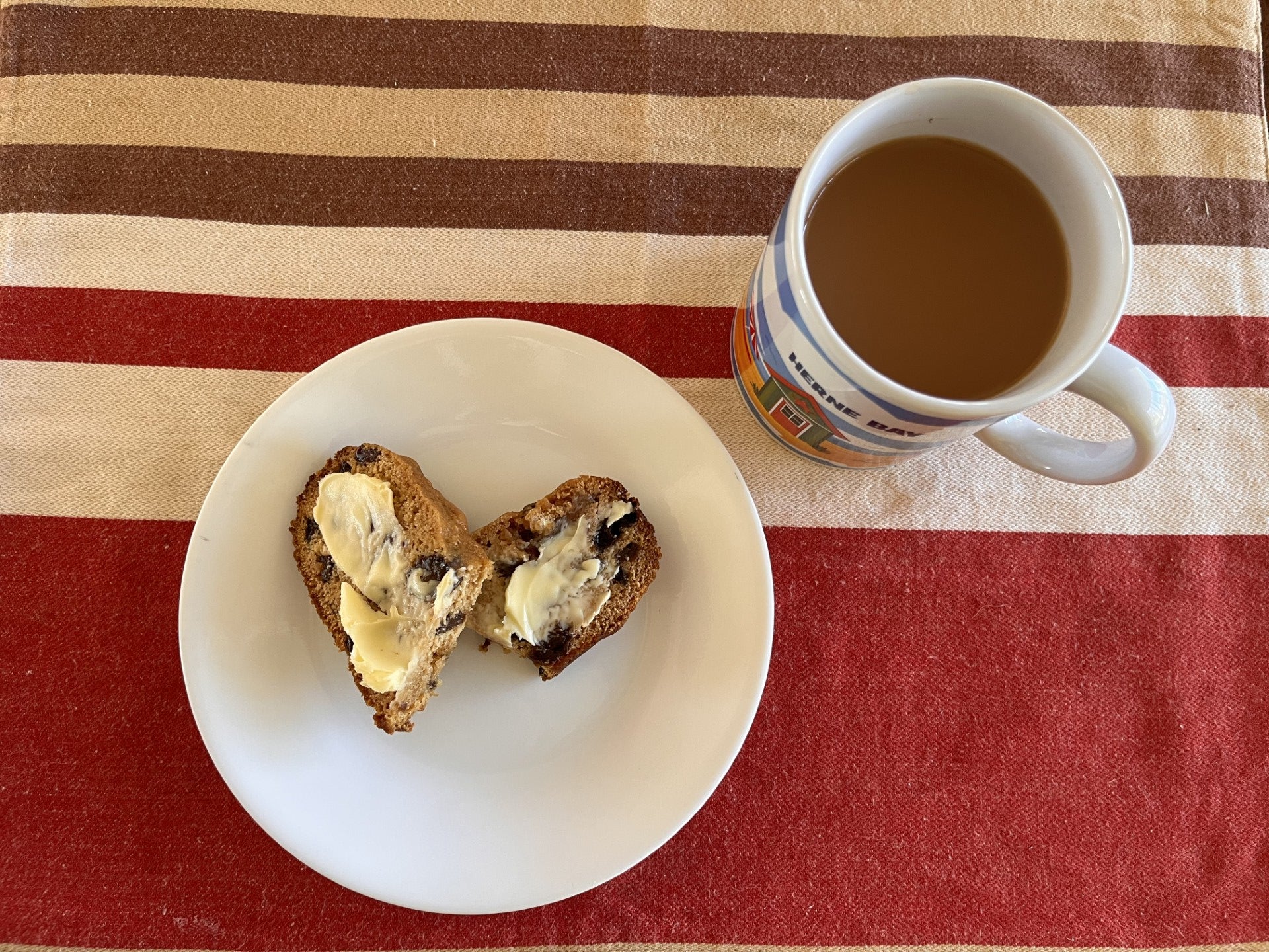cup of tea with a buttered slice of earl grey tea bread