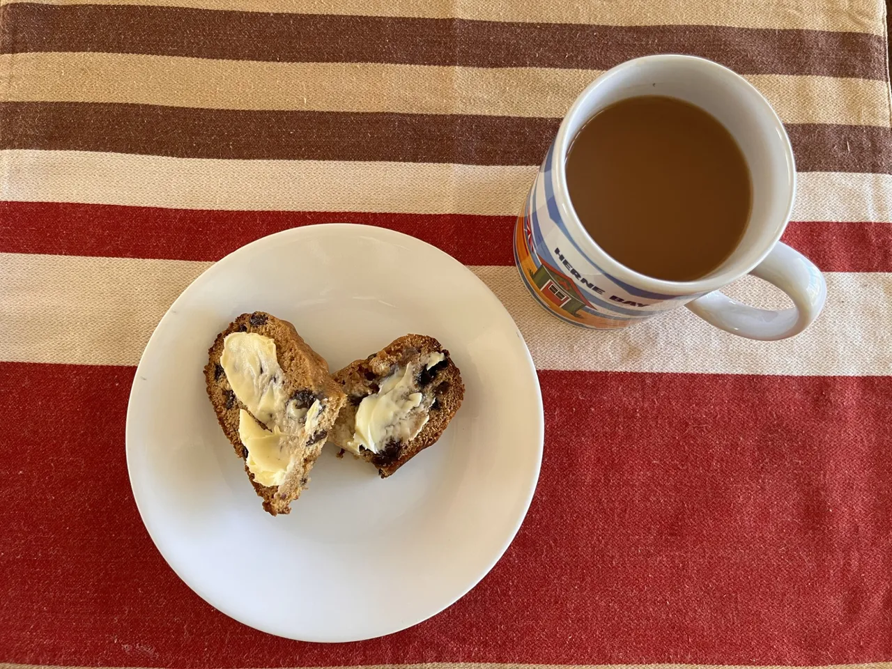 cup of tea with a buttered slice of earl grey tea bread