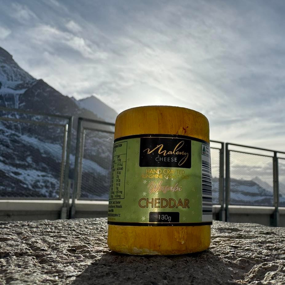 A picture of Maleny Cheese in the foreground, and behind the alps of Switzerland