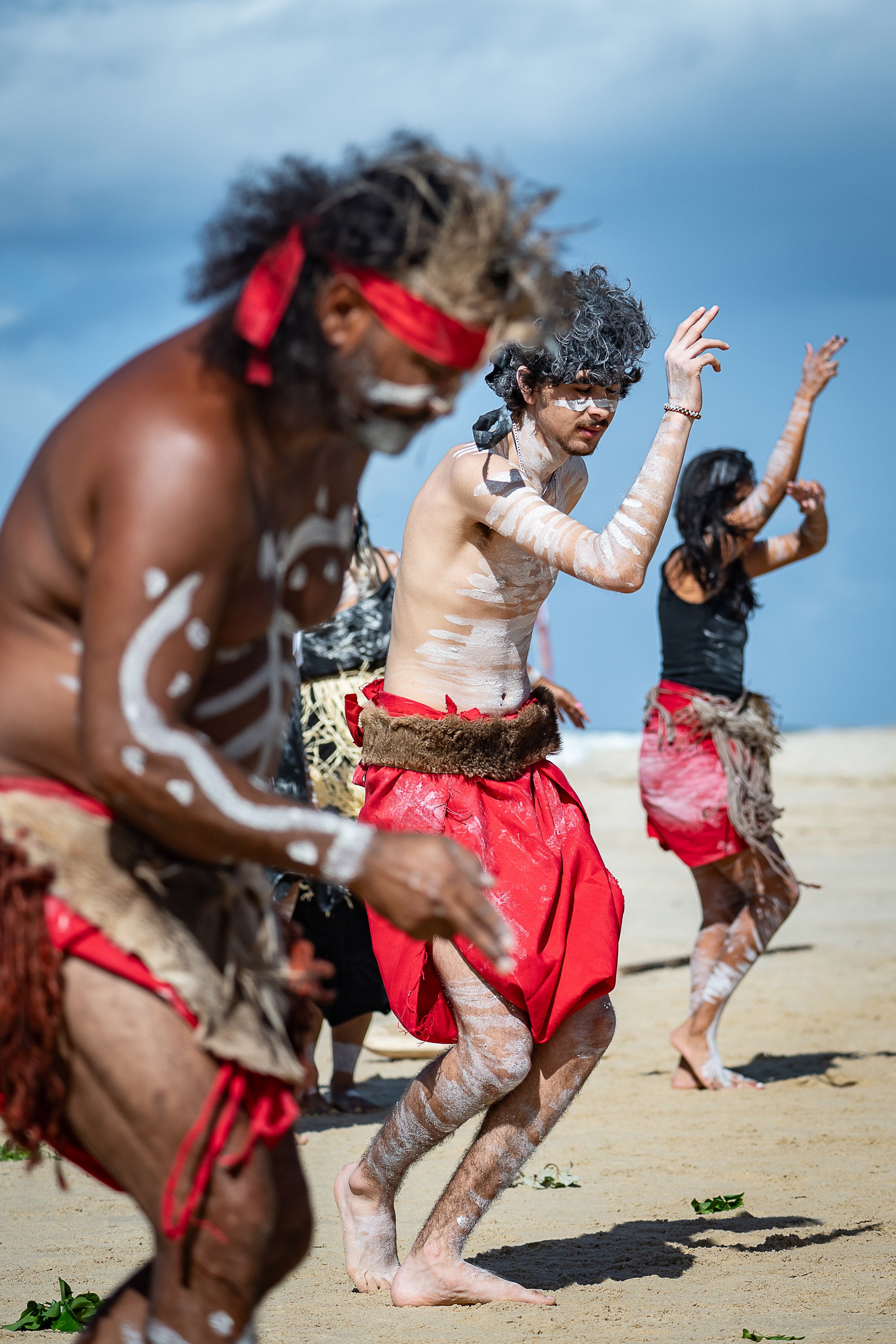 First nations dancers on the beach