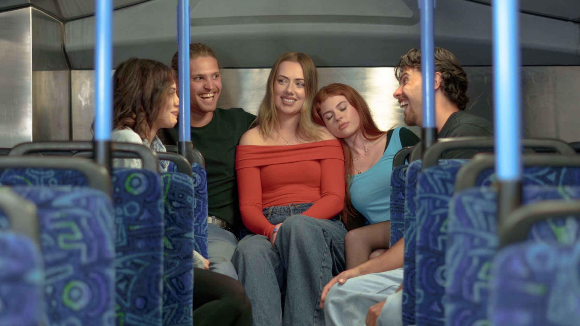 Young people travelling home on the bus at night. 