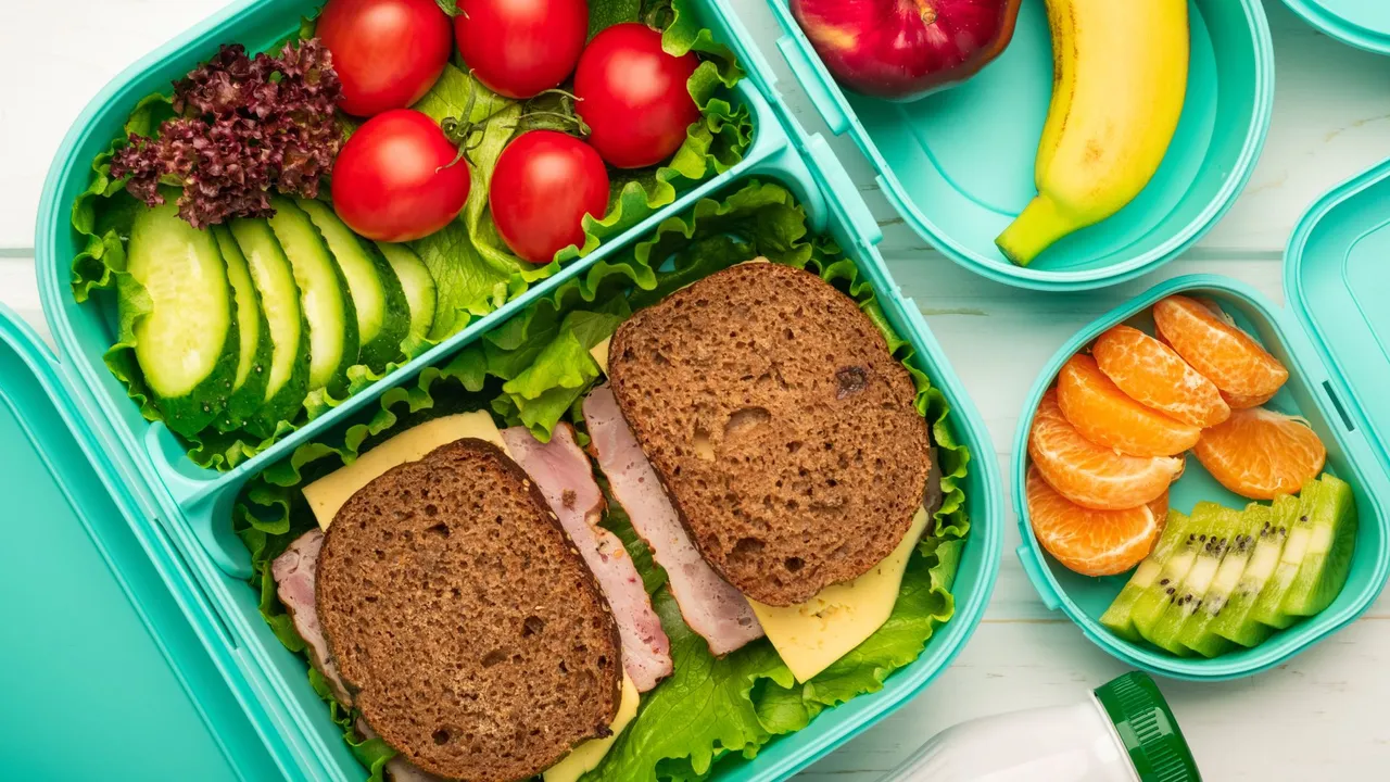 Top view of school lunch boxes with sandwiches and vegetables with fruits the concept of a healthy and balanced diet