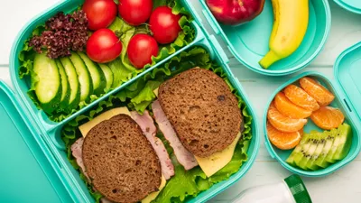 Top view of school lunch boxes with sandwiches and vegetables with fruits the concept of a healthy and balanced diet