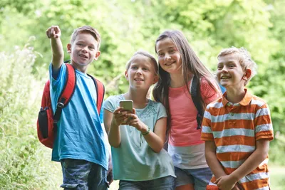 kids outside trying to find a geocache