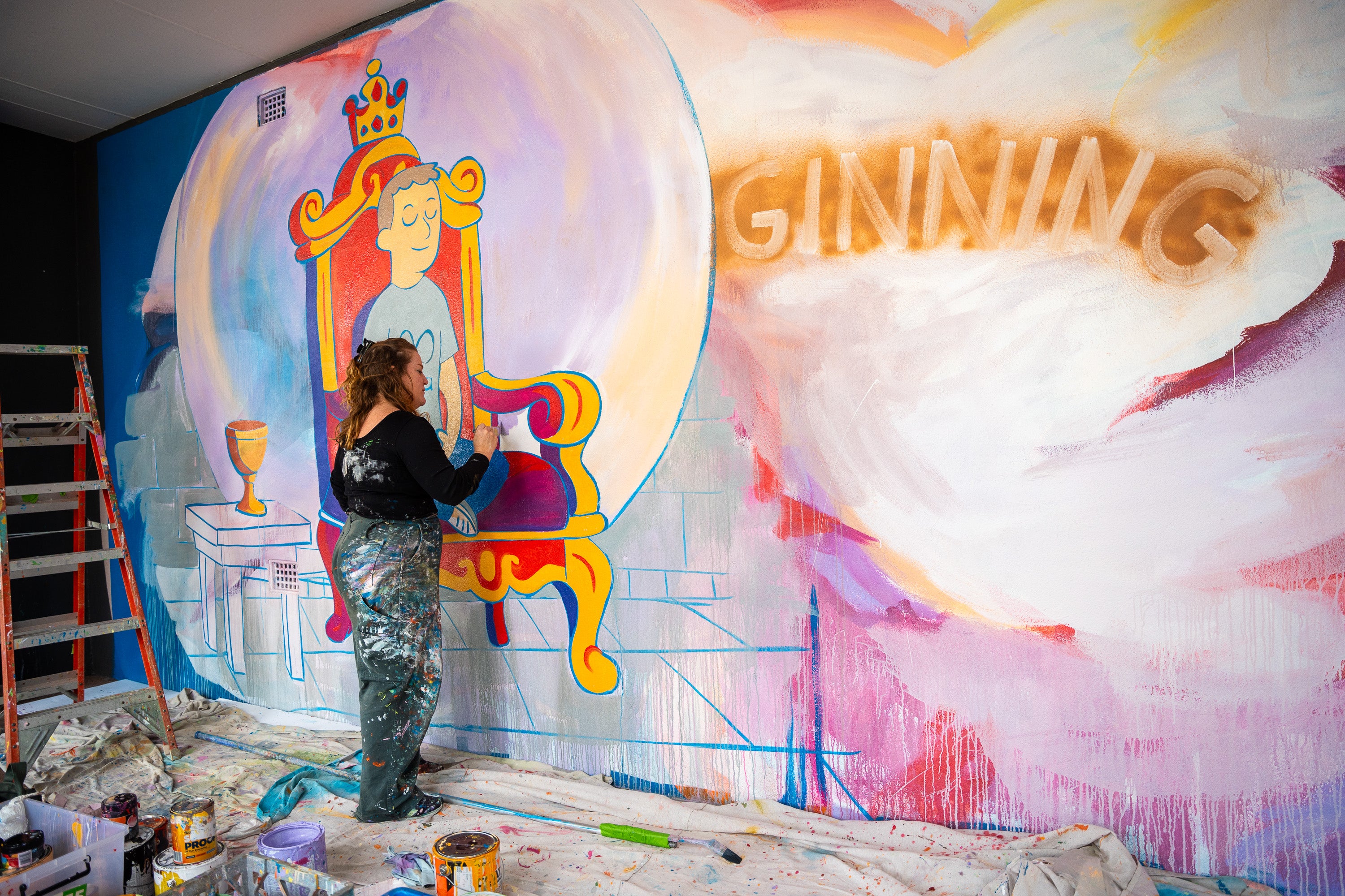 Alison Mooney painting a mural