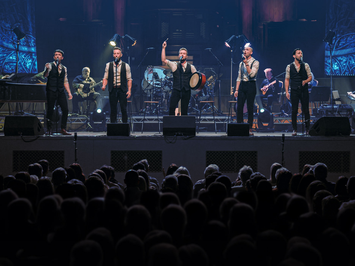 Shamrock Tenors, five singers on stage performing well known irish songs. 