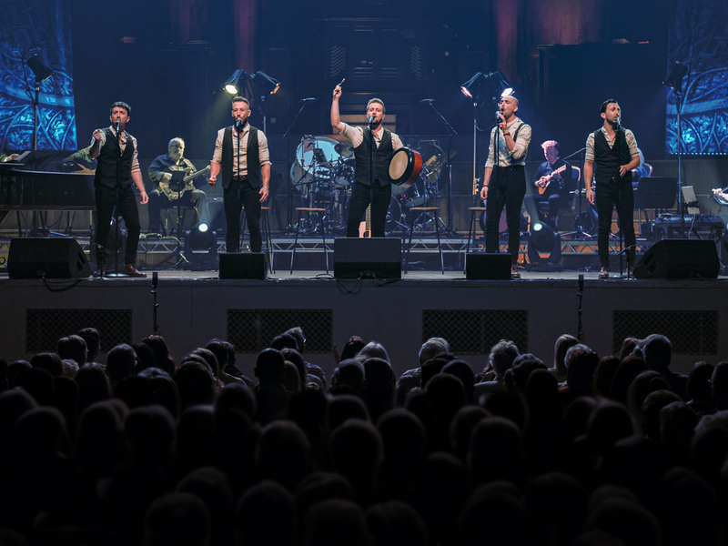 Shamrock Tenors, five singers on stage performing well known irish songs.