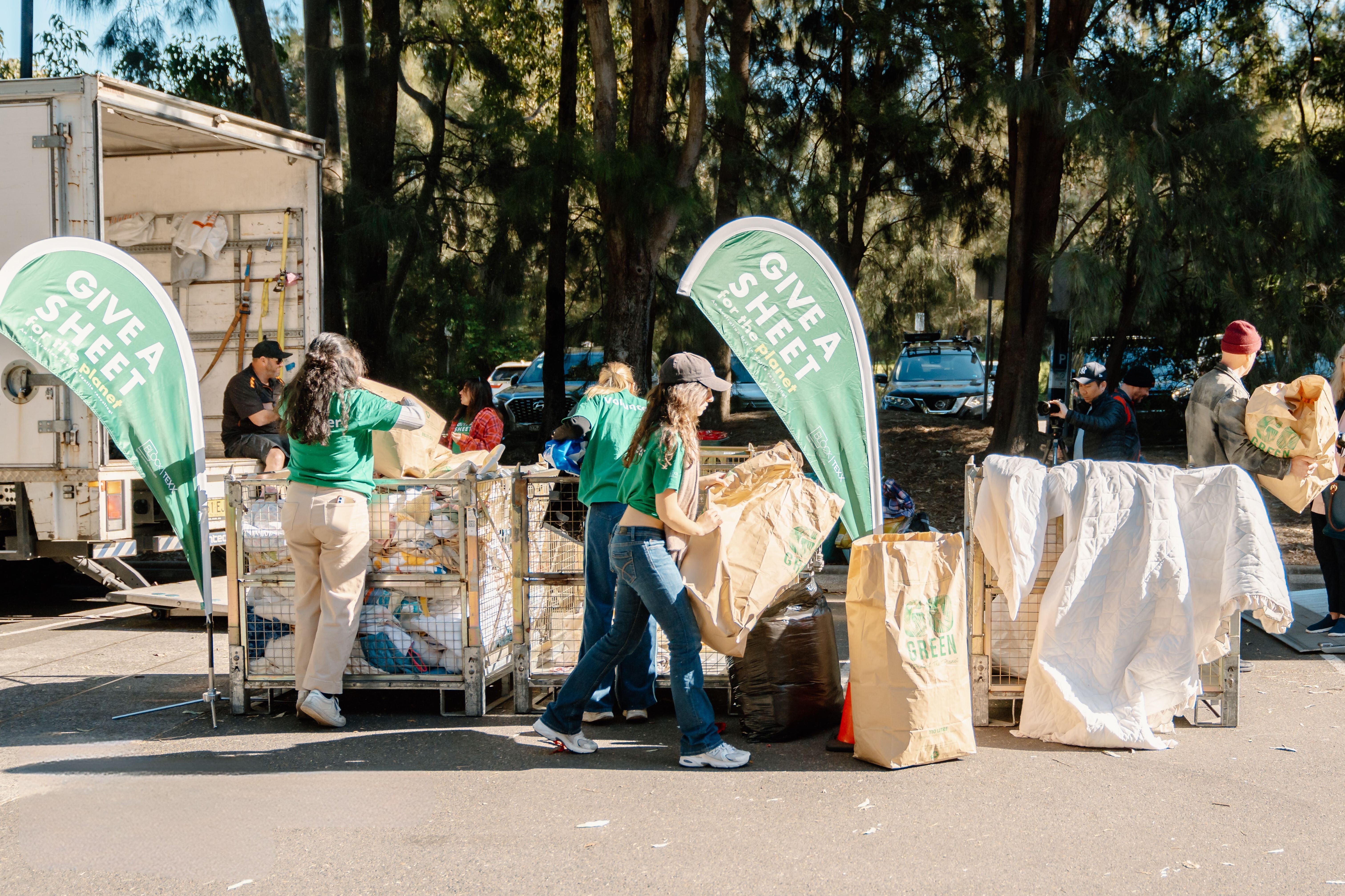Volunteers sorting through bins and bags of donations 