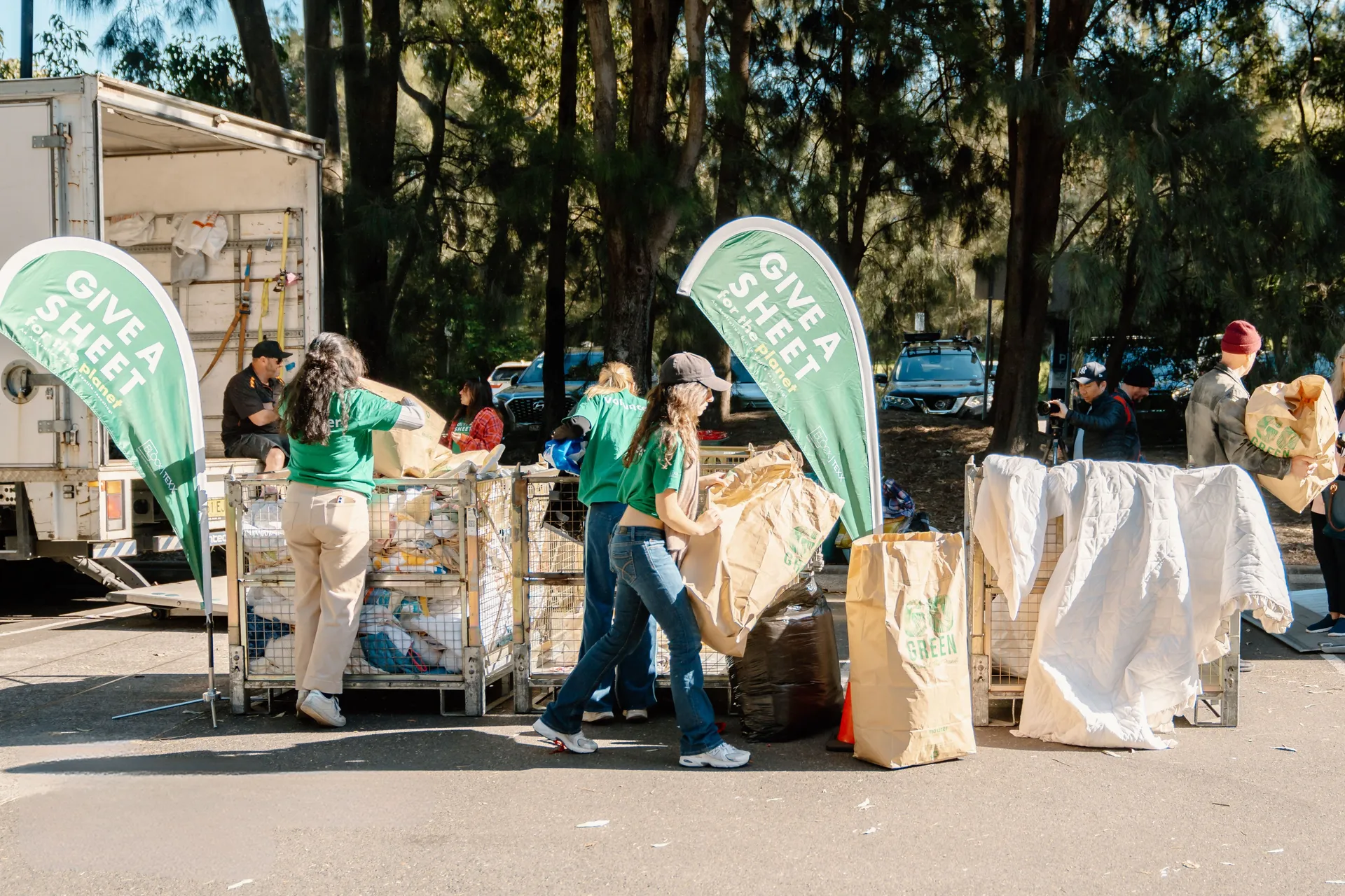Volunteers sorting through bins and bags of donations