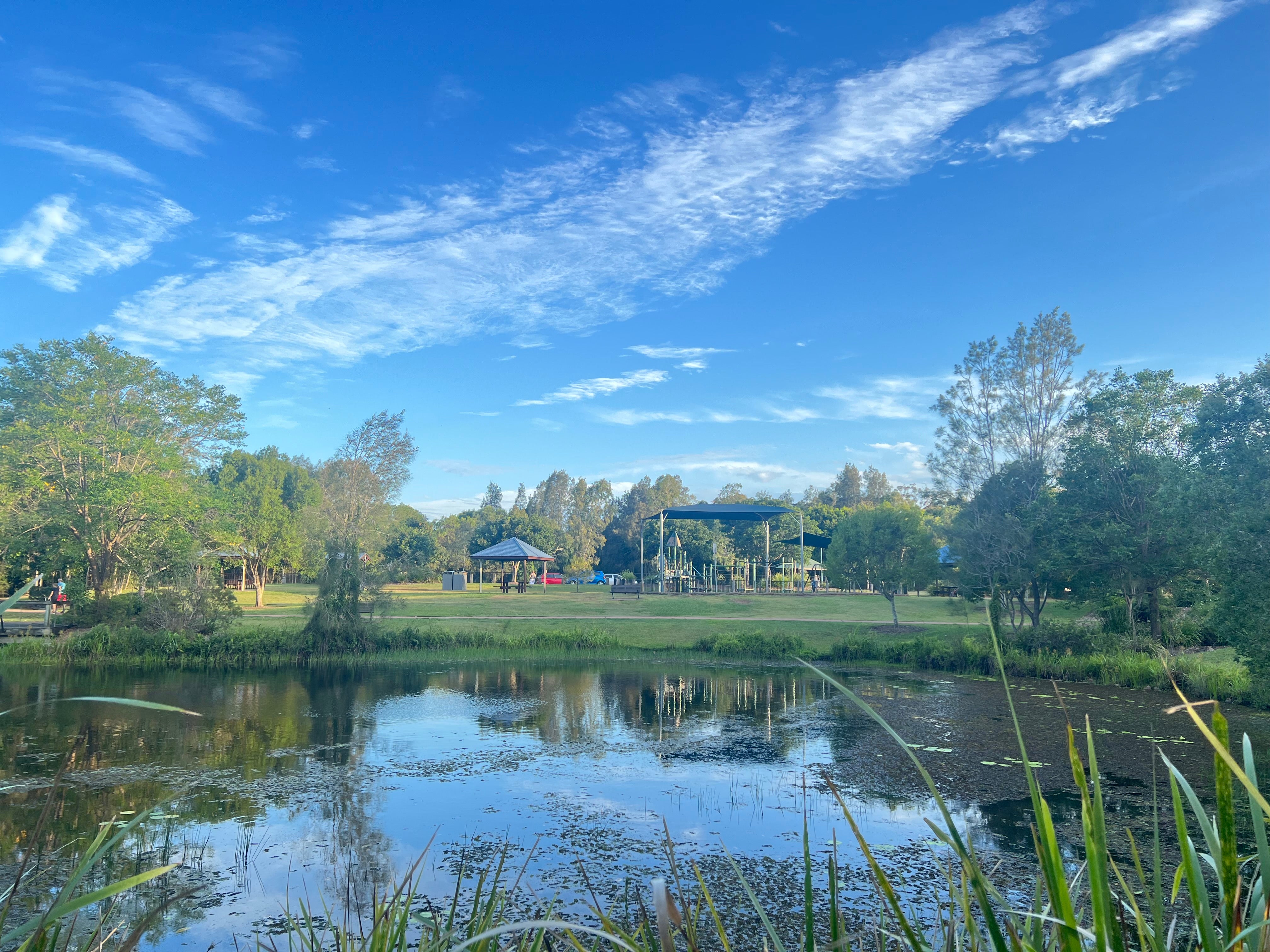 Pond near fenced playground