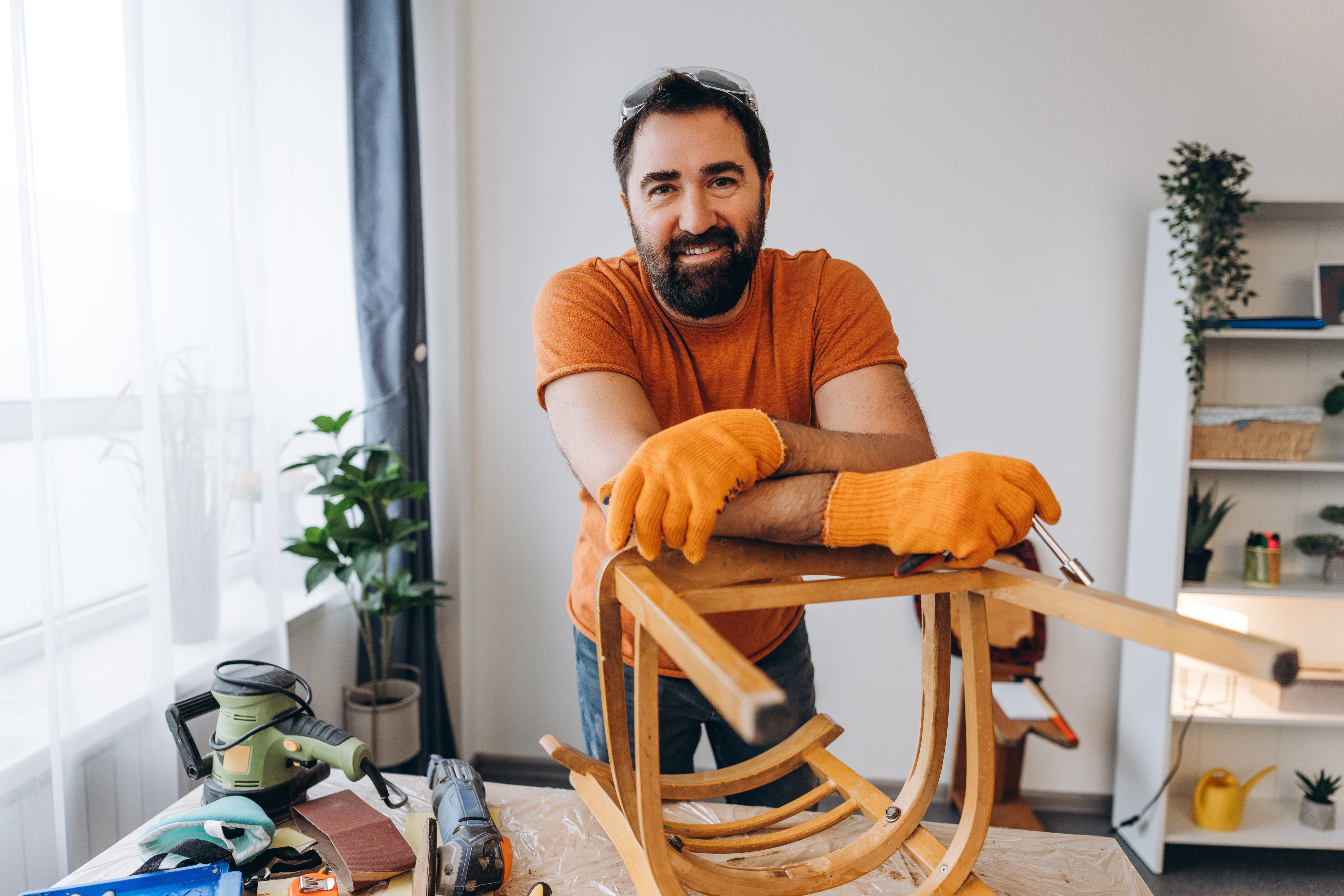 man with a chair turned upside down
