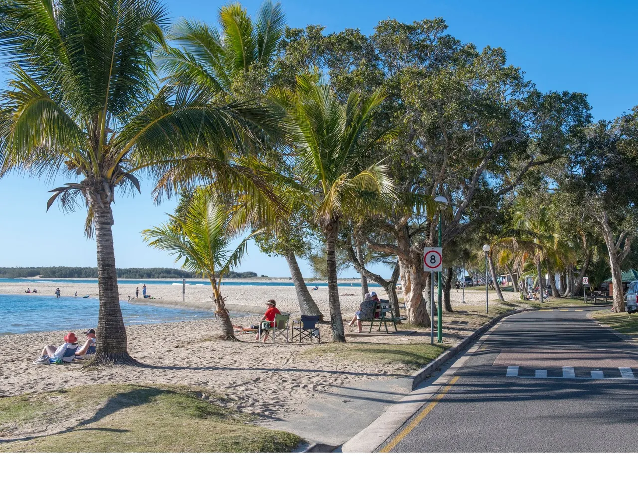 Cotton Tree riverbank and people enjoying the beach and water