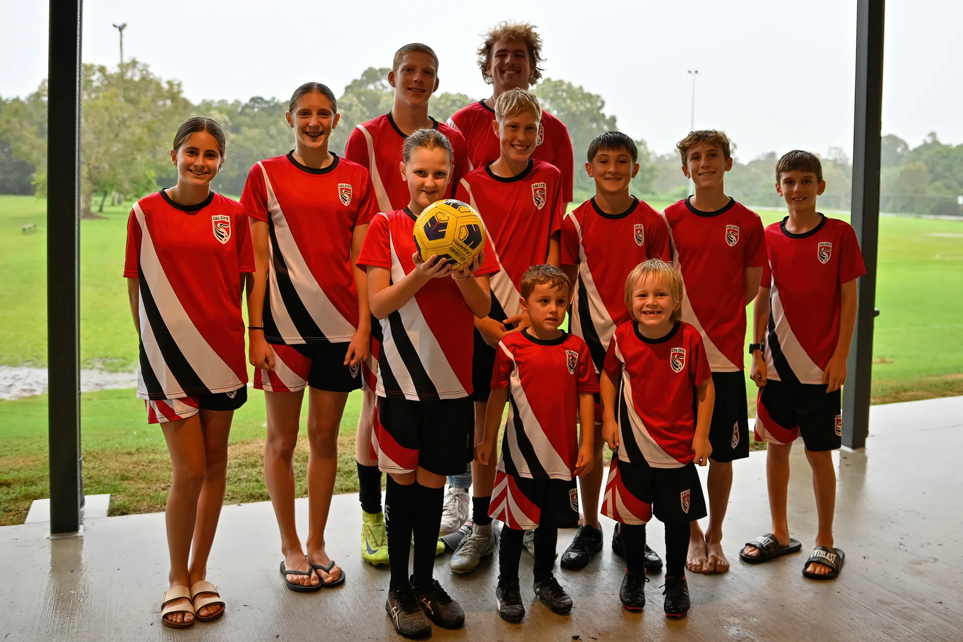 A group of Caloundra City Soccer Club players gather at the opening of their new clubhouse.