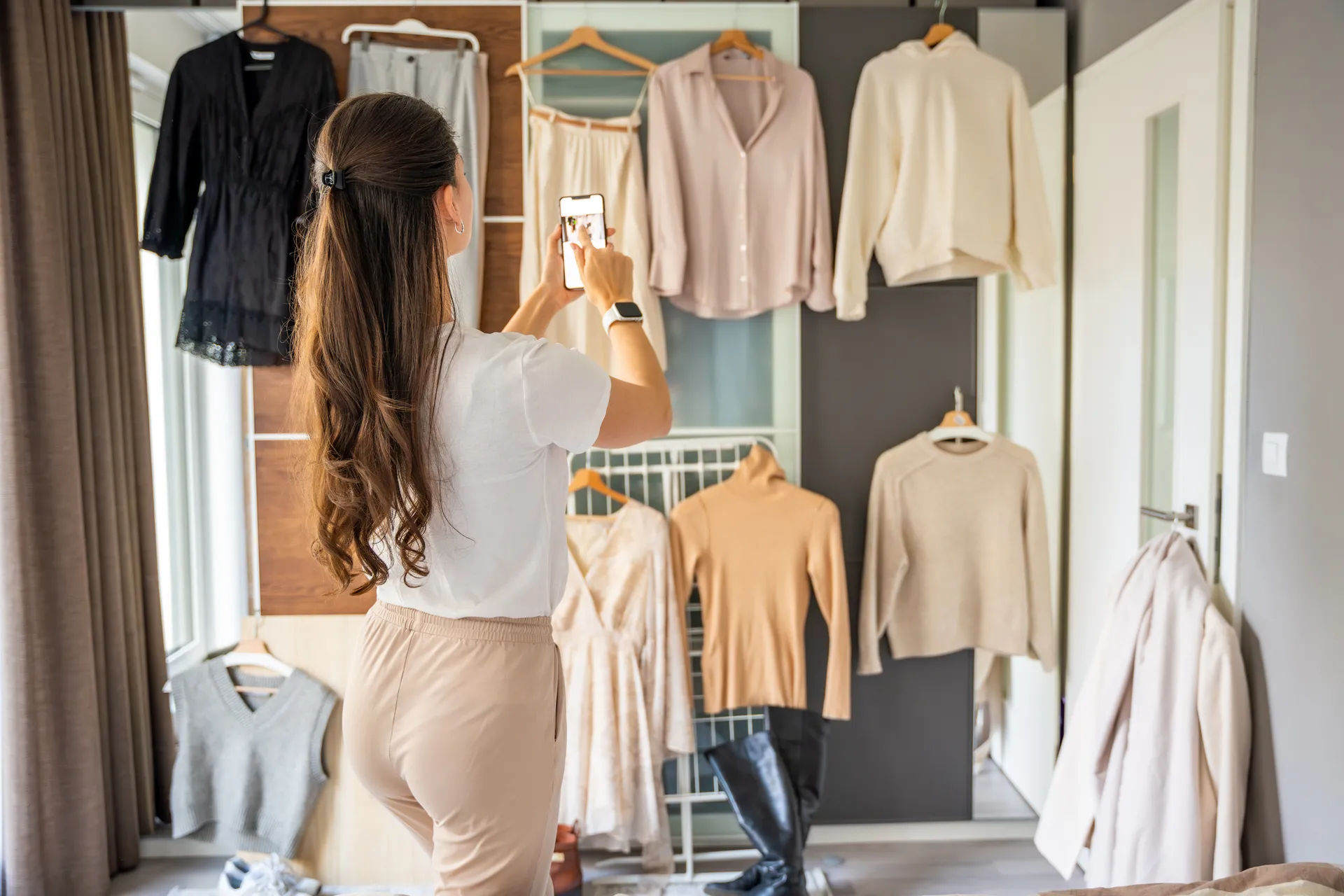 lady taking pictures of her wardrobe clear out