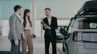 Couple in an ev showroom with a salesman