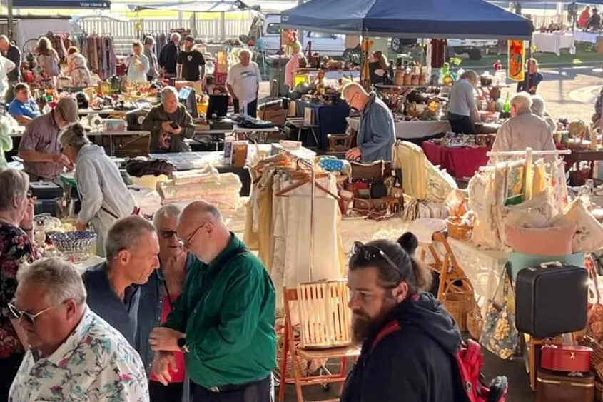 People wandering through a market set up.