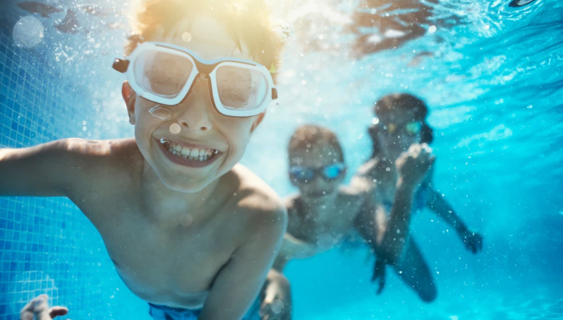kids swimming under water in a pool